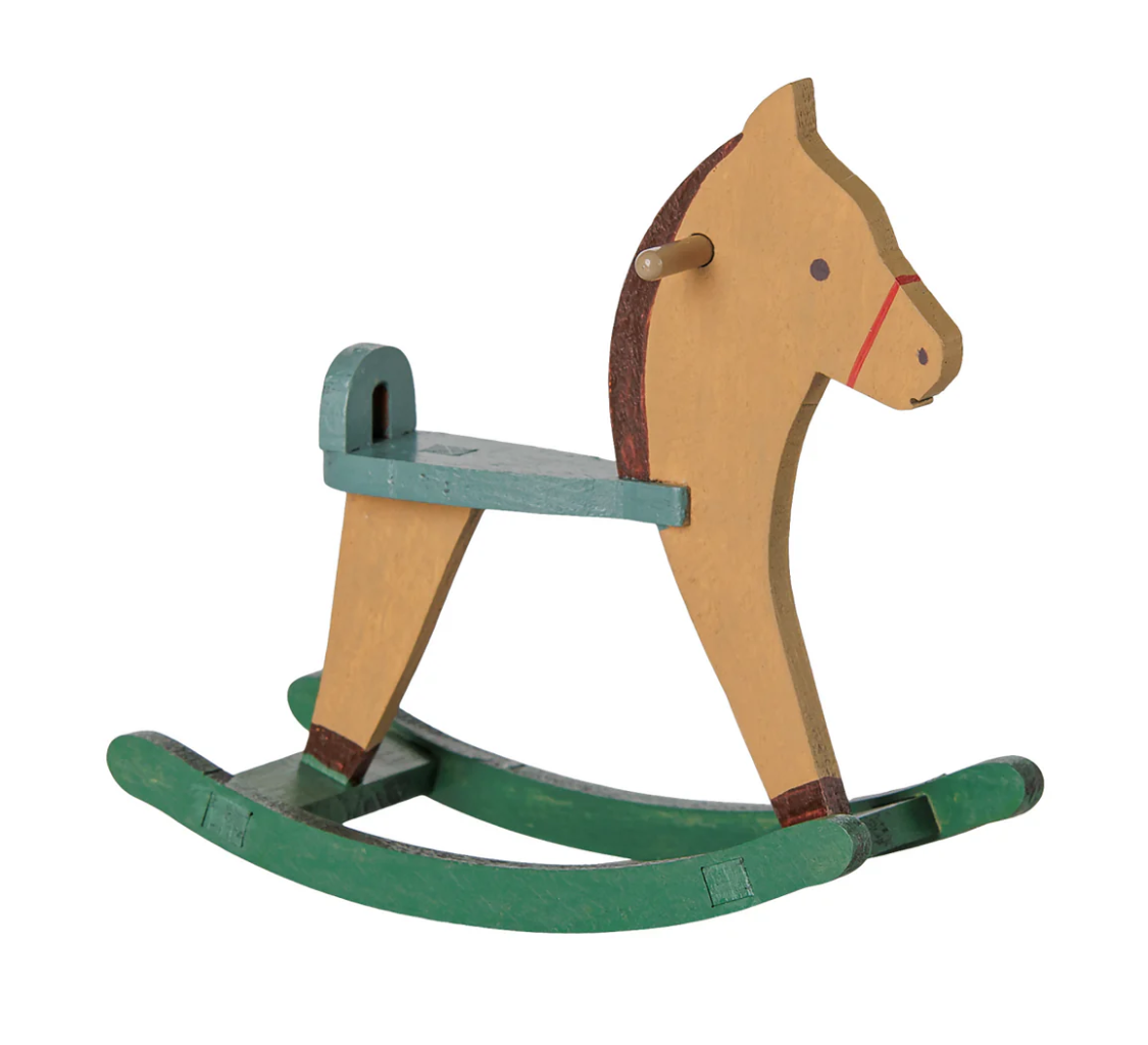Miniature wooden toy rocking horse in light brown with green base, on a white background