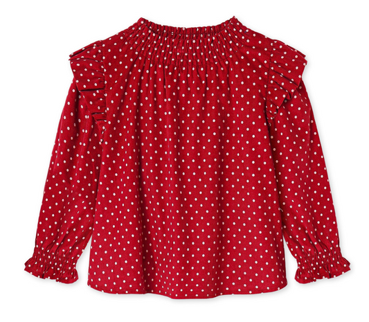 Red ruffly long sleeve blouse with white polka dots on a white background