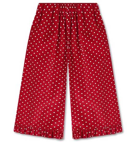 Red wide leg pants with white polka dots and a ruffle at the hem on a white background