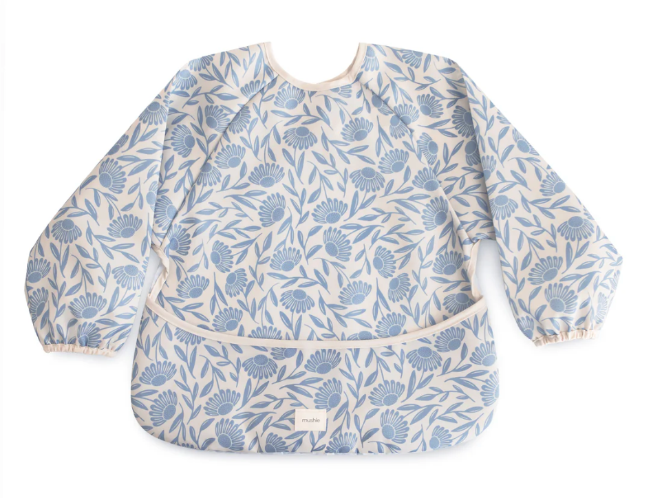 Baby bib with blue floral pattern on a white background