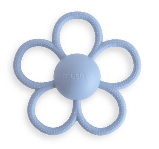Blue flower-shaped teething ring with 'mushie' branding on a white background