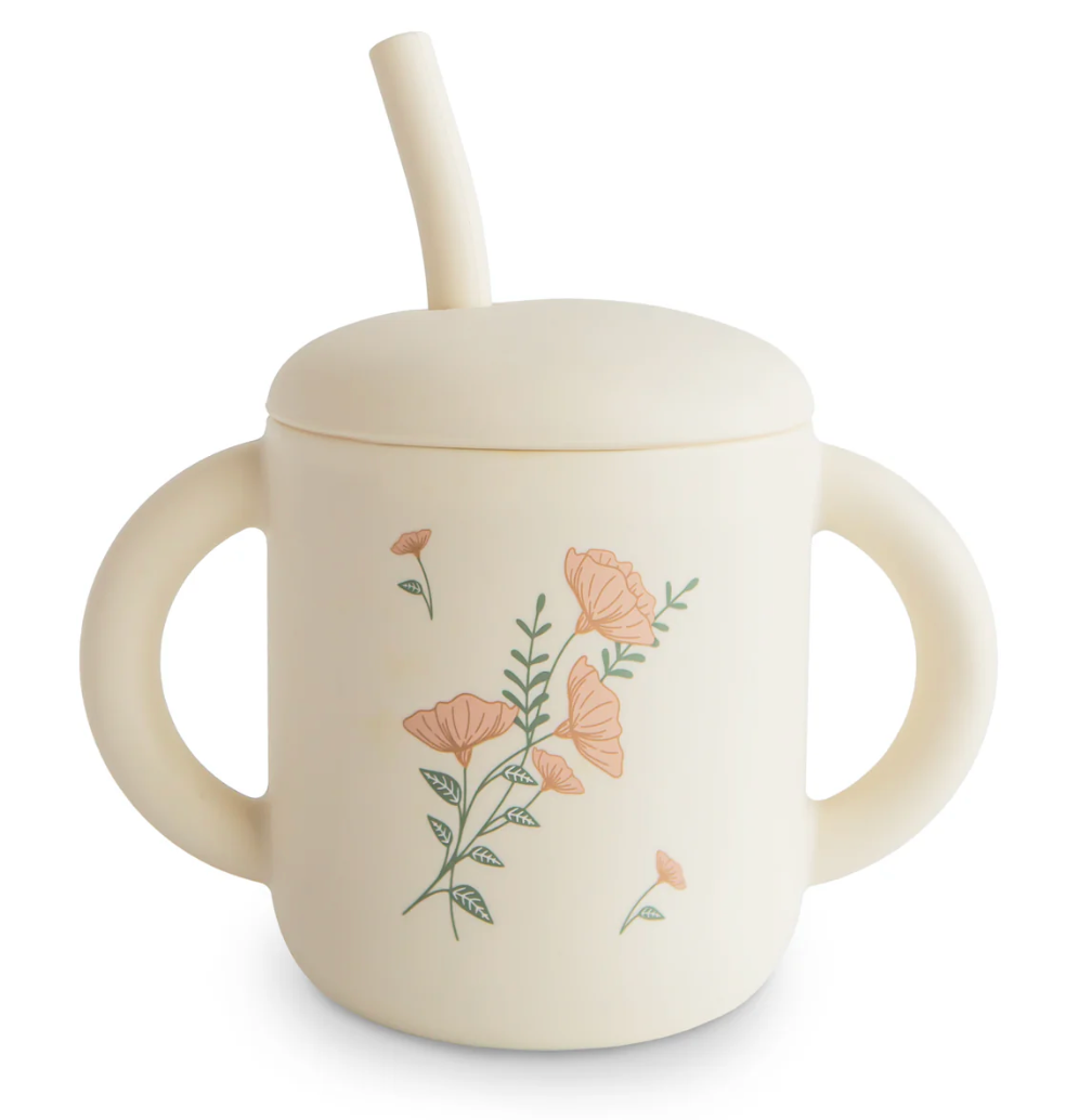 Children's sippy cup with floral design on a white background