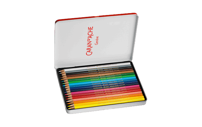 Set of colored pencils in a Grumbacher tin on a beige background