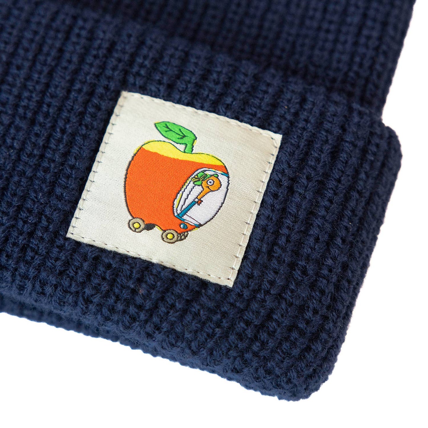 Navy blue knit beanie with a colorful patch featuring a cartoon character inside an apple.