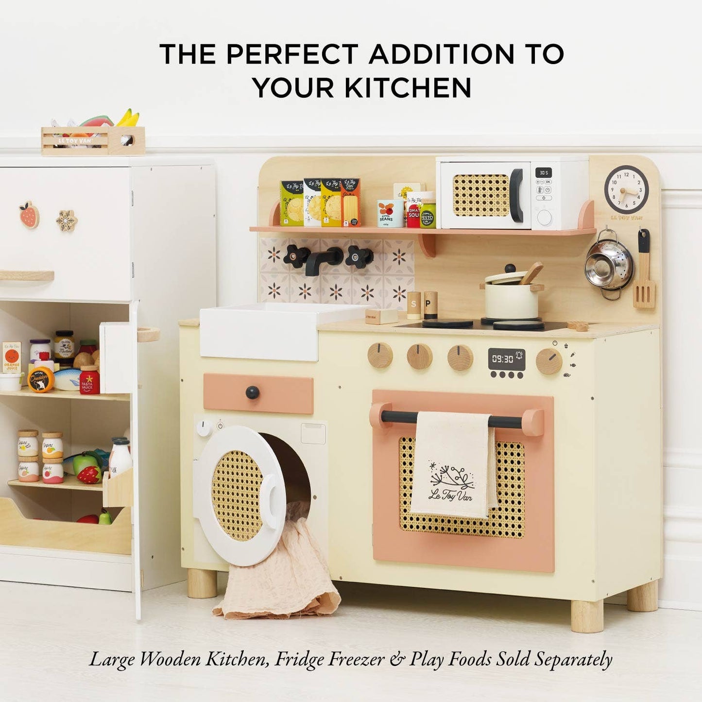 Children's play kitchen set with toy appliances and items on a white background