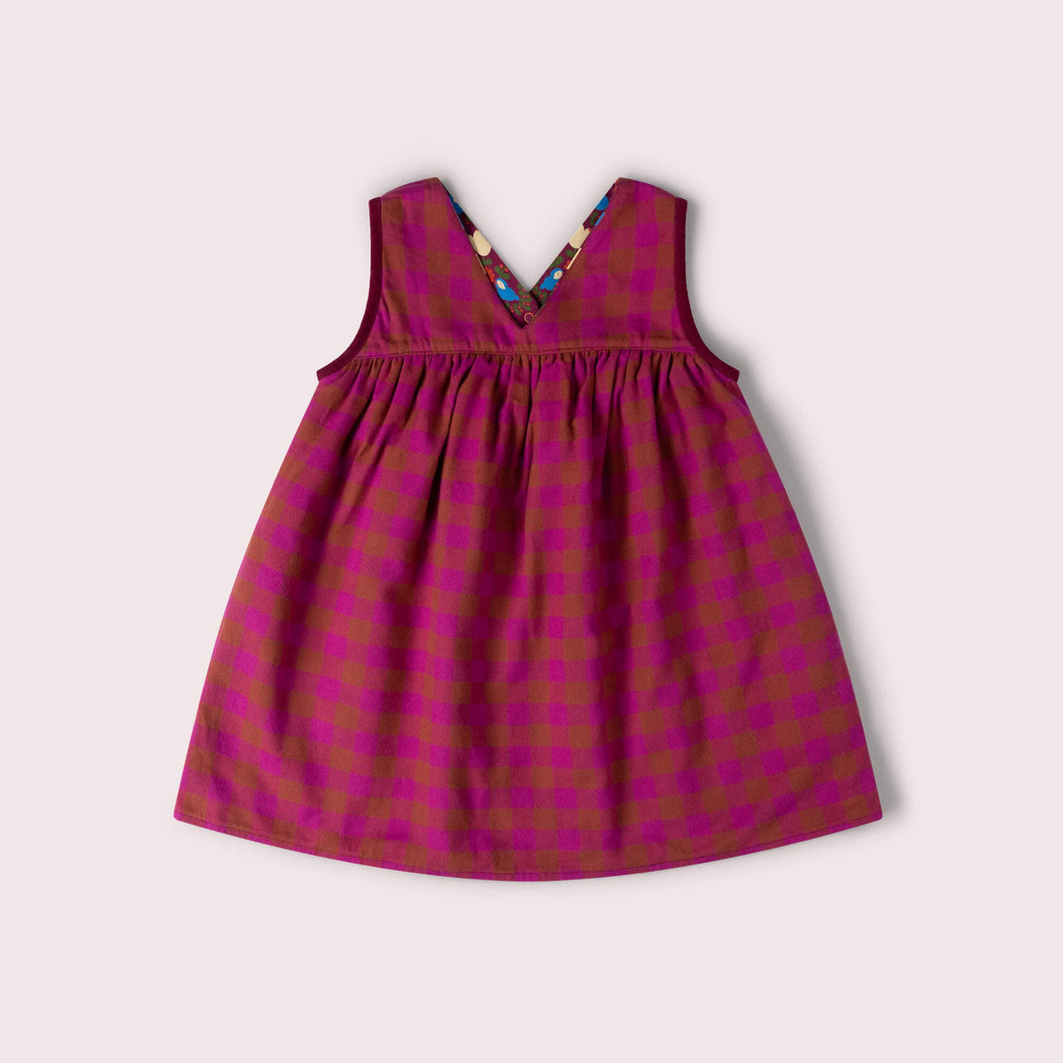 Pink and rust checked reverse side of a sleeveless reversible swing dress.