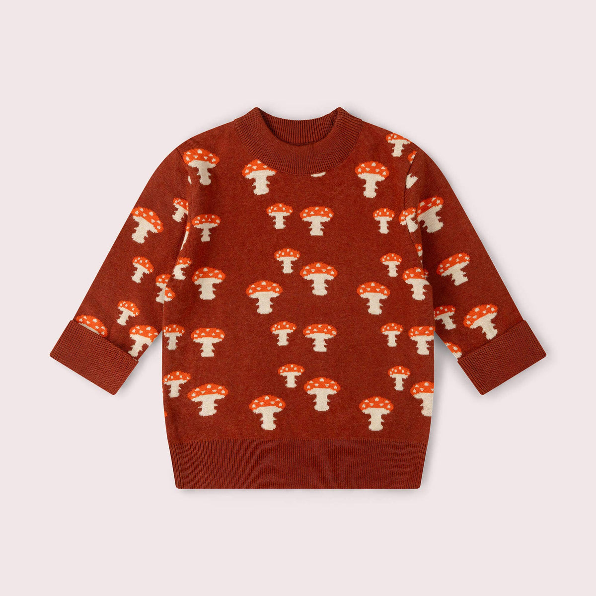 Rust knitted jumper with cream and red mushroom motifs and ribbed trim.