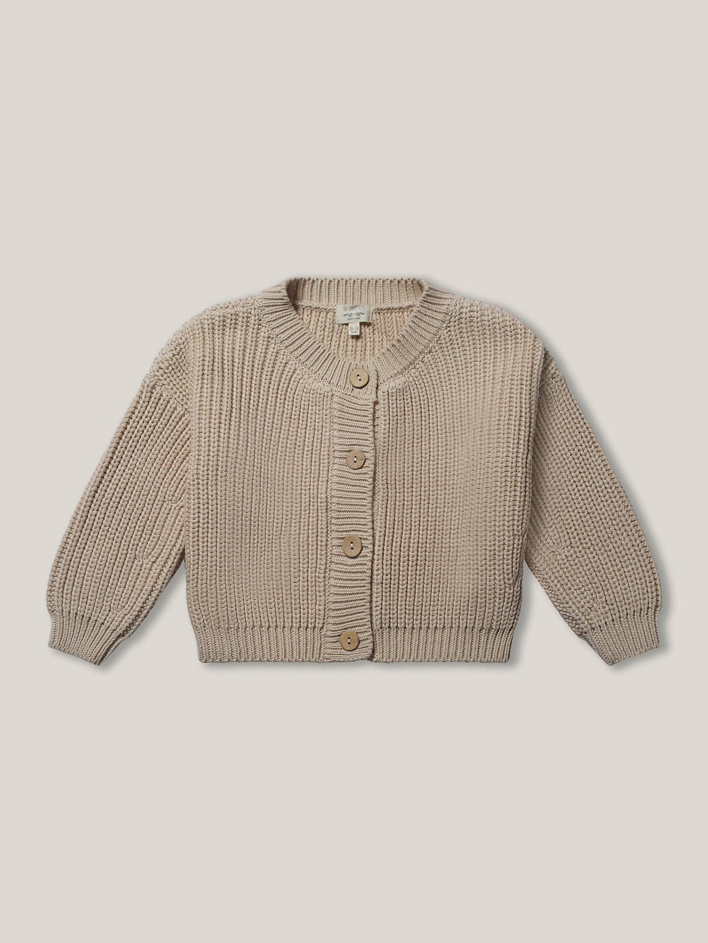 Beige knitted cardigan on a beige background