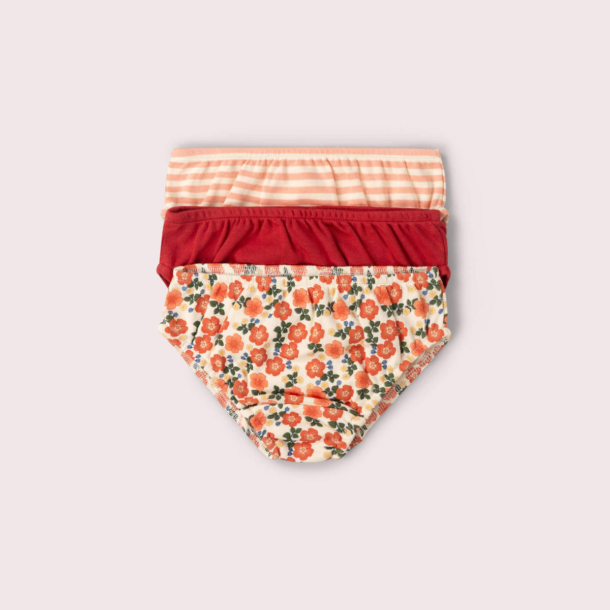 Three pairs of children's underwear in floral, striped and solid colors.