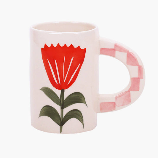 White mug with a red tulip design and a checkered handle on a white background