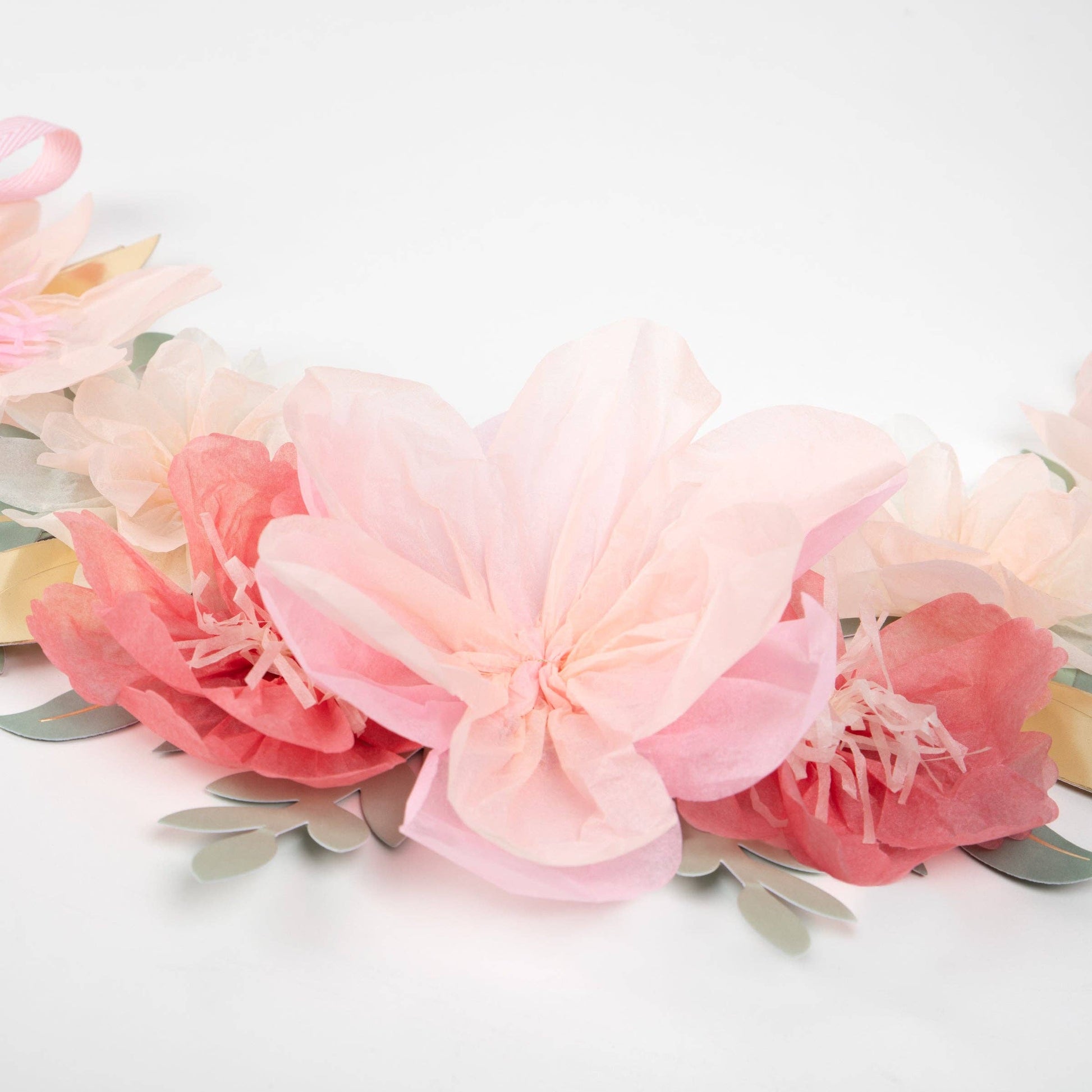 Floral headband with pink and peach flowers on a white background