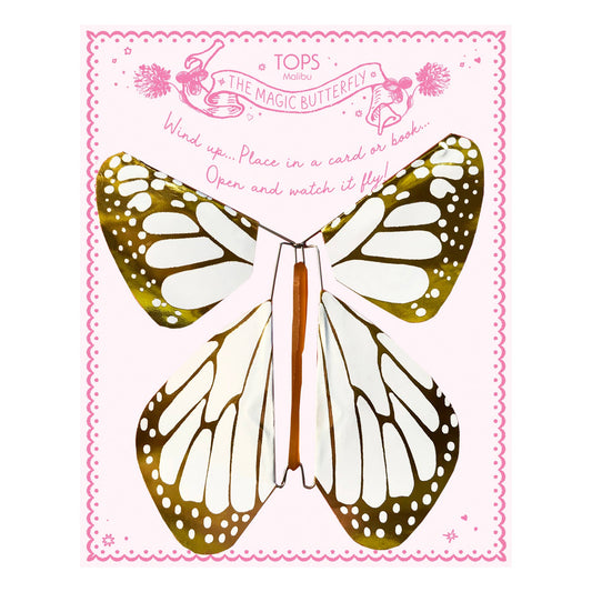 Butterfly-shaped toy with gold and white wings on a pink background