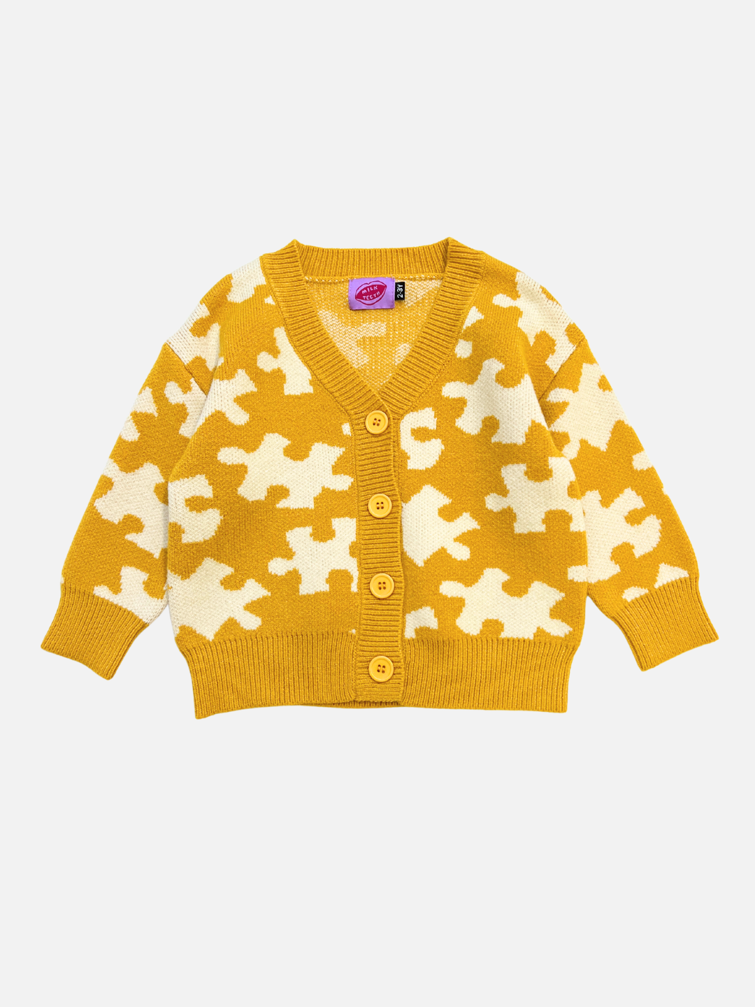 Yellow cardigan with white puzzle piece pattern on a light gray background