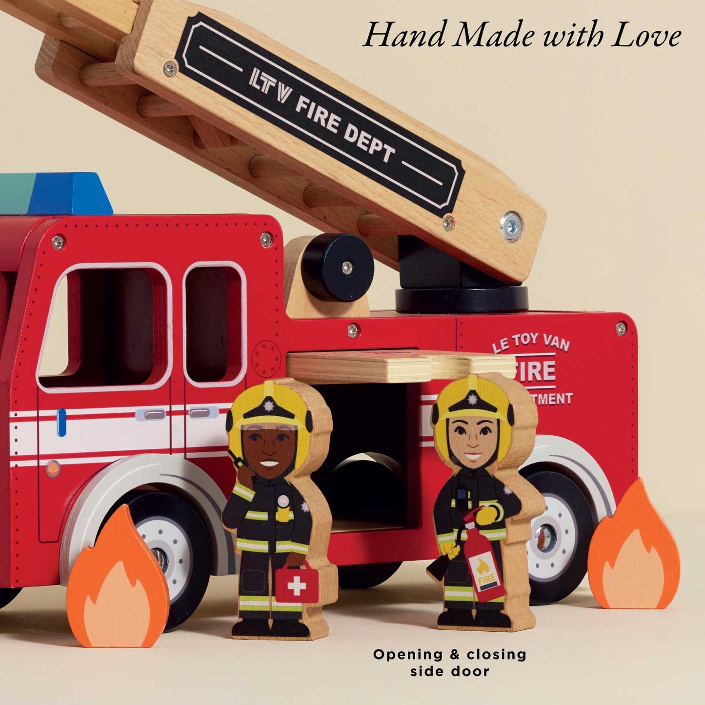 Toy fire truck with wooden ladder and firefighters in front, labeled 'Le Toy Van Fire Department'.