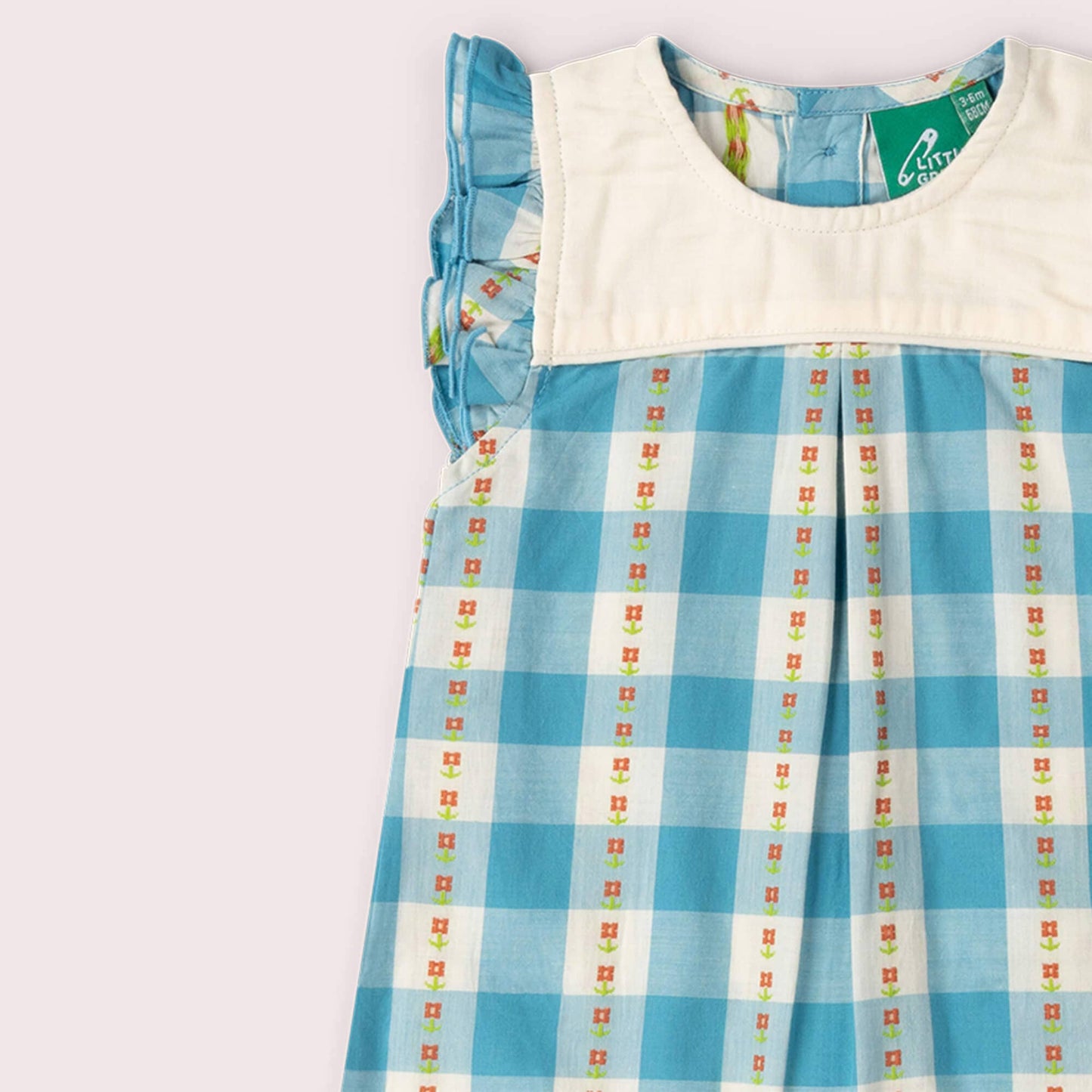 Children's dress with blue checkered pattern on a white background