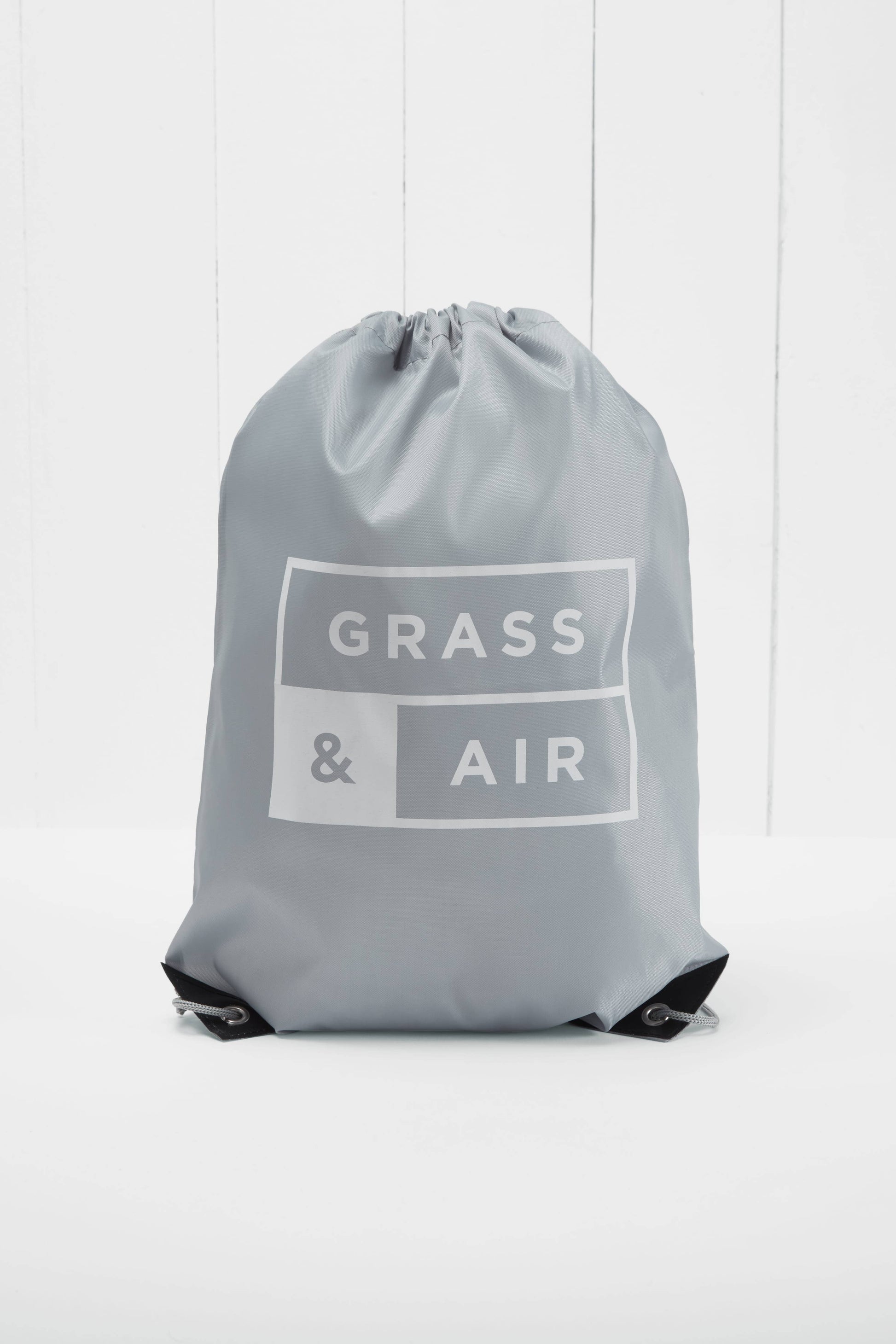 grey tote bag with the words "Gras & Air" on it on a white background