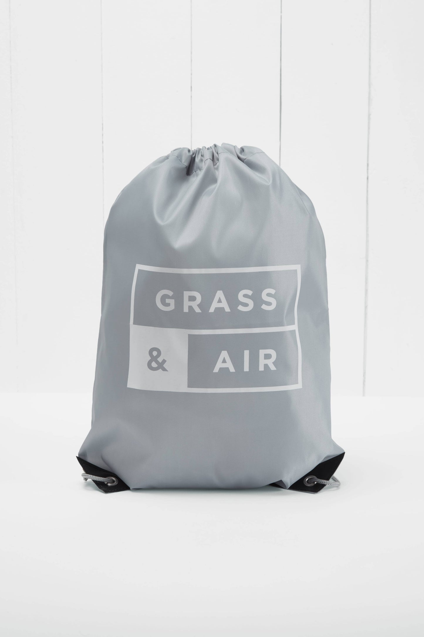 grey drawstring bag with Grass & Air logo on white background