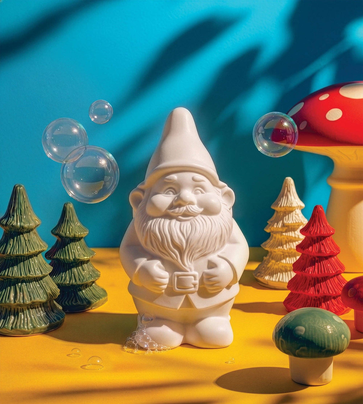 White gnome-shaped soap with bubbles and decorative trees on a bright background