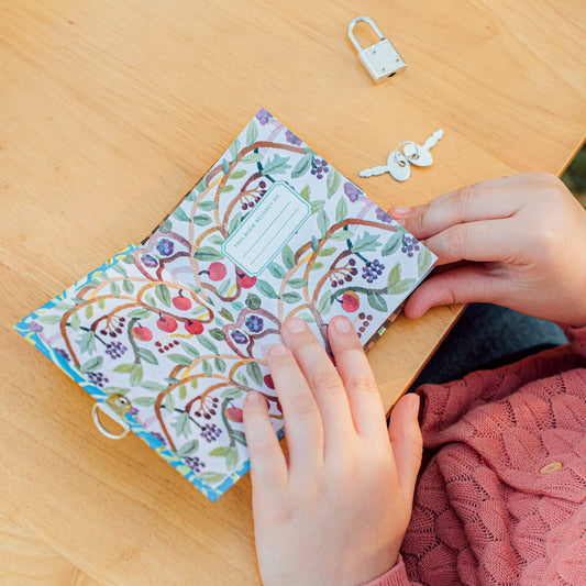 A small colorful whimsical journal on a table