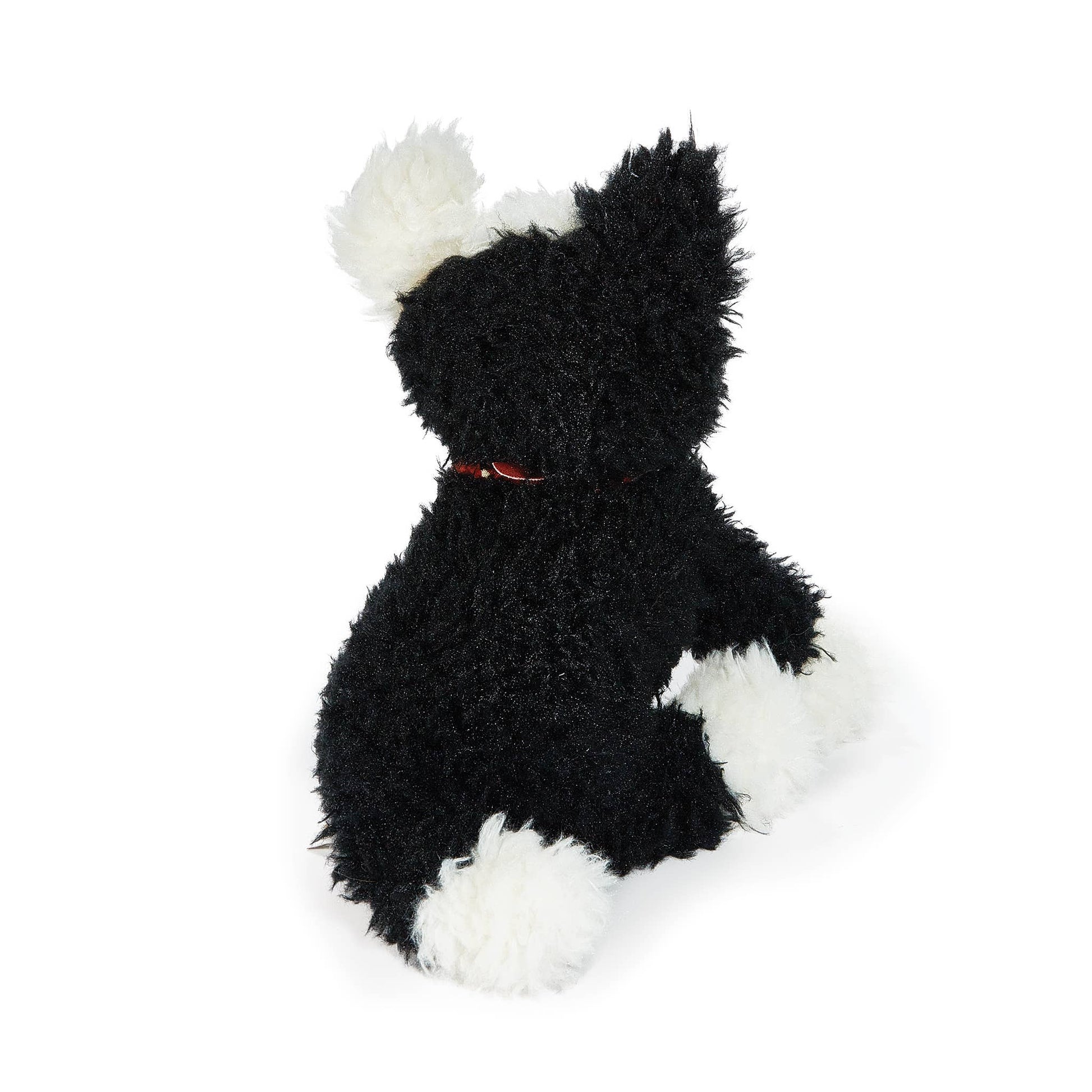 Black and white plush toy on a white background