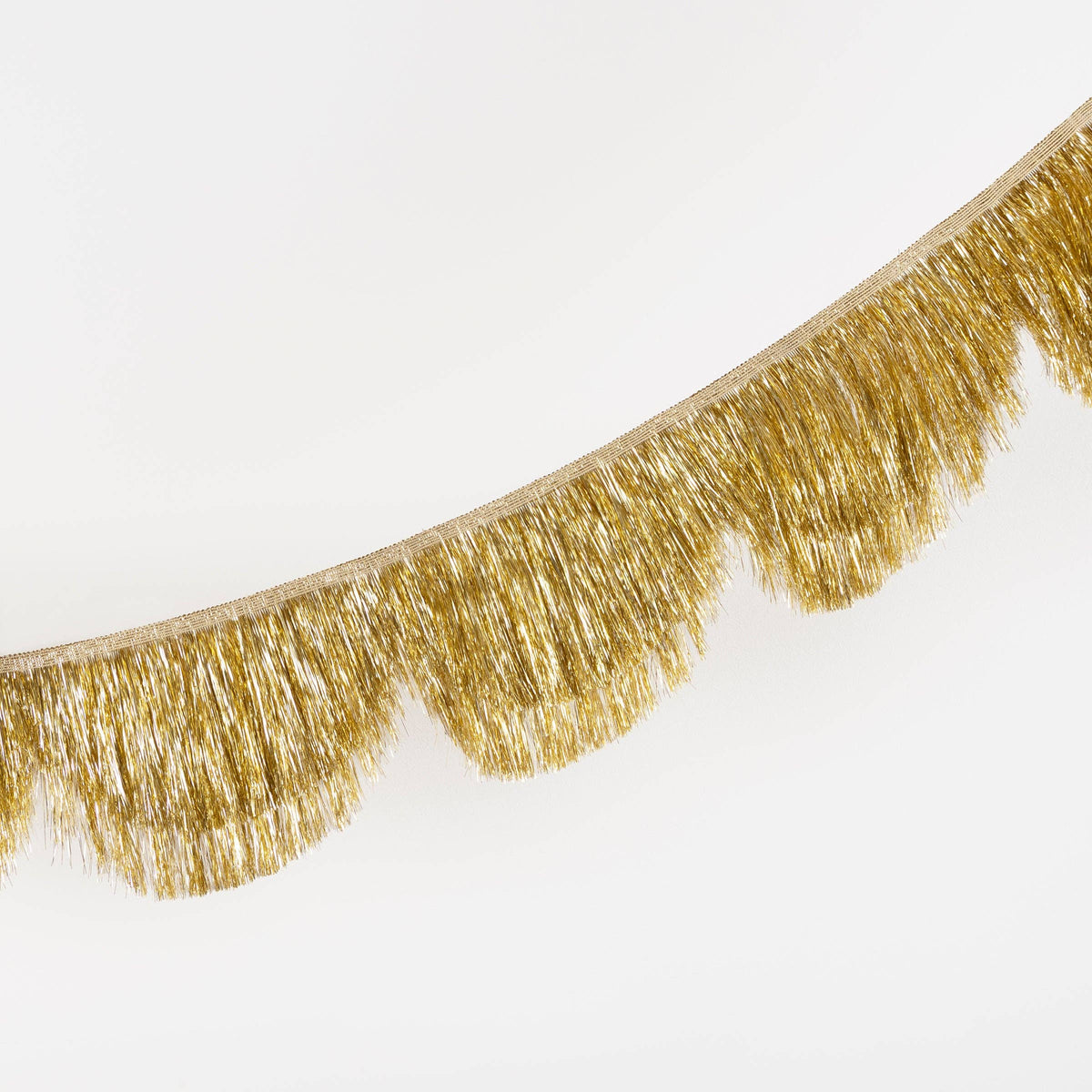 Gold fringe garland on a white background