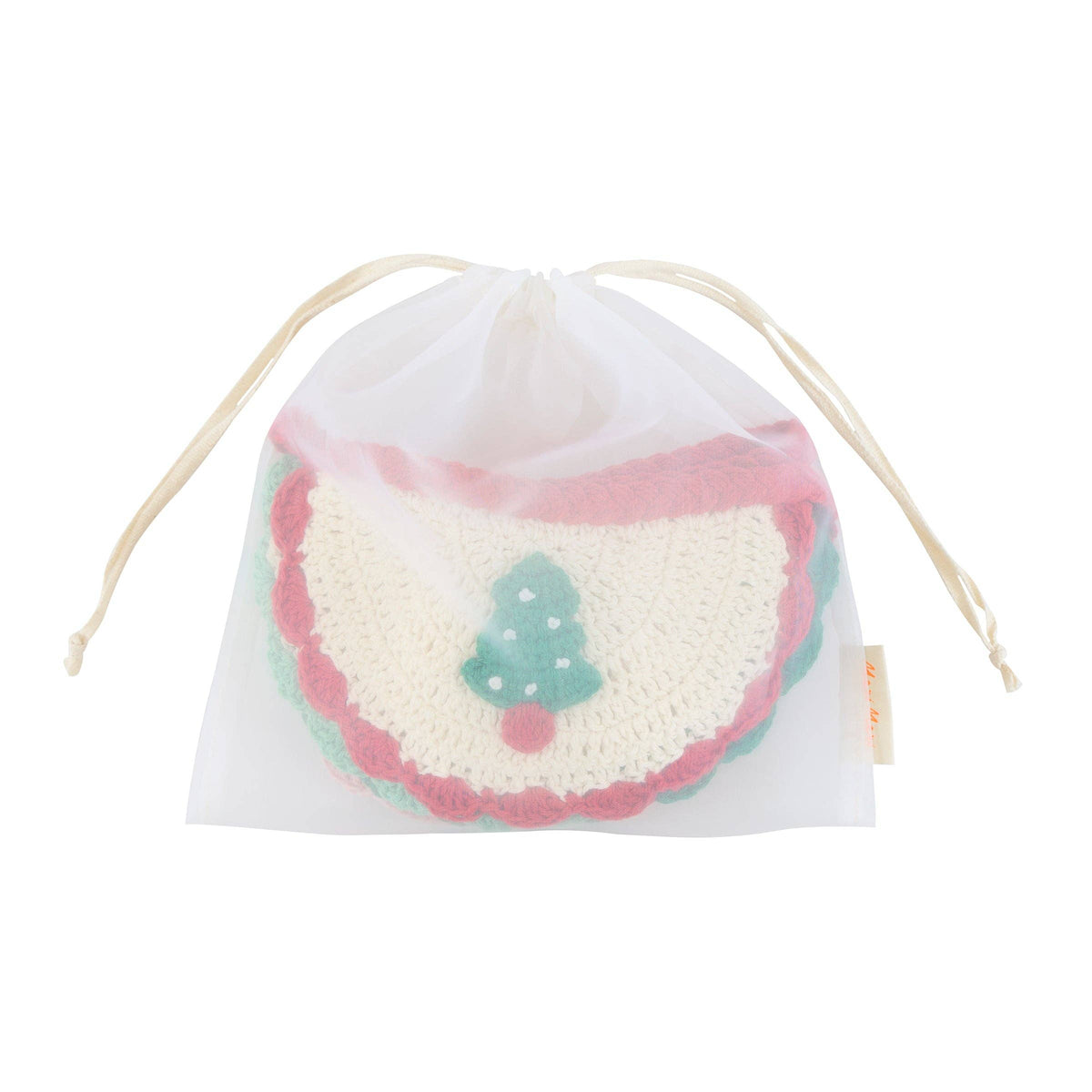 A white mesh drawstring bag containing a round, cream-colored crocheted or knit patch with pink scalloped edges and a small green tree applique, shown on a plain white background.