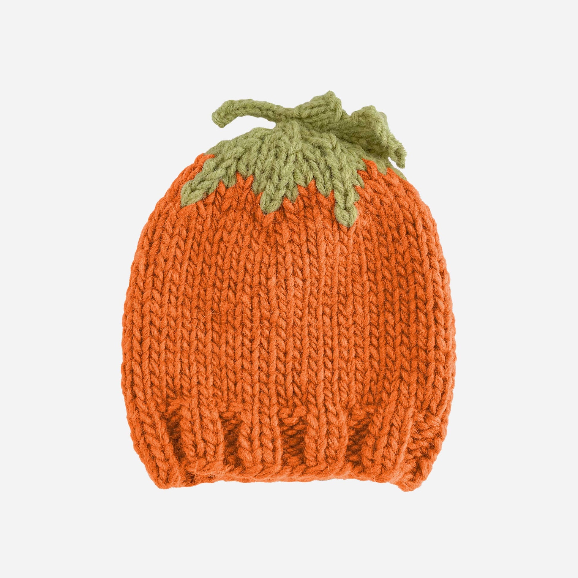 Knitted pumpkin hat with a green stem on a white background