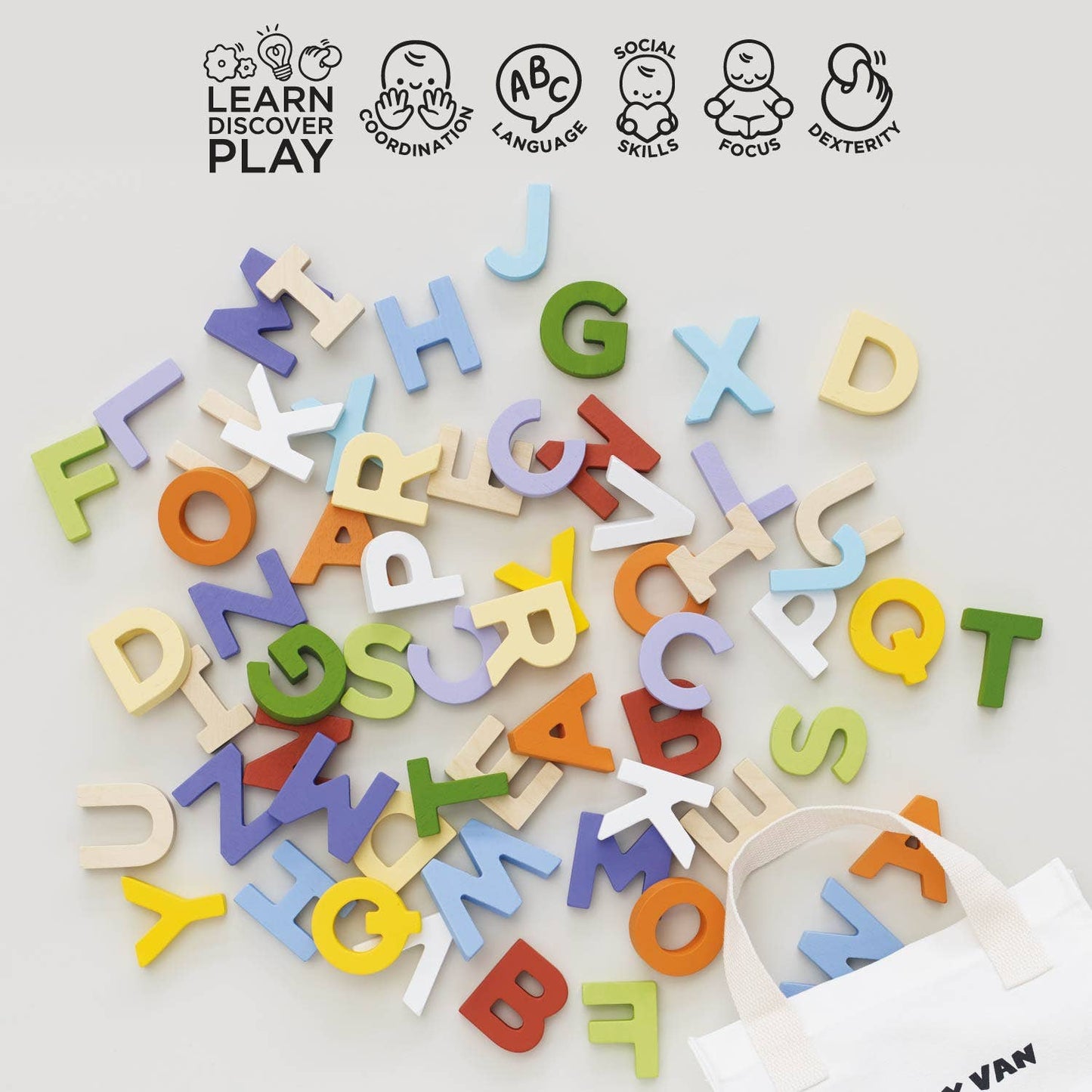 Colorful wooden letters scattered on a white surface with 'Learn Discover Play' branding.
