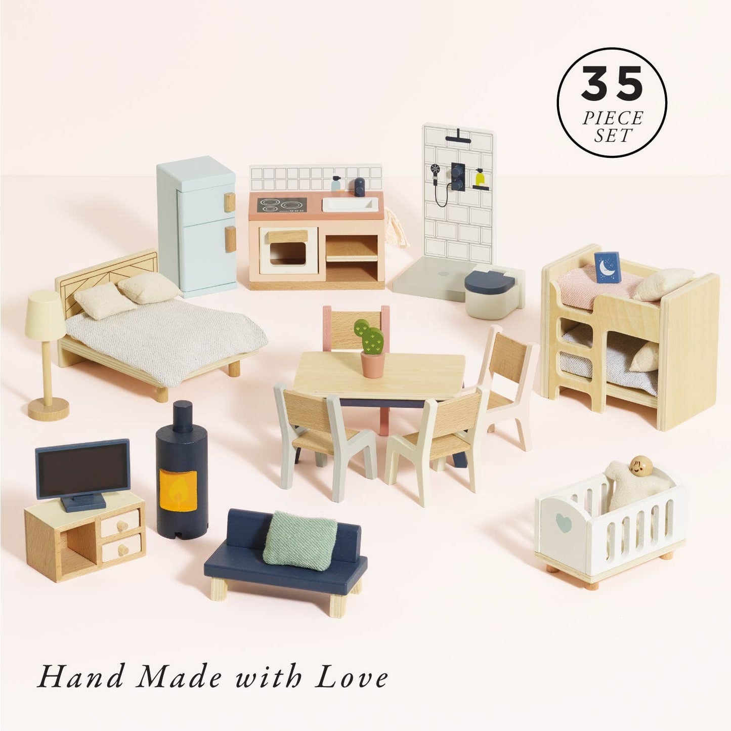 Set of miniature dollhouse furniture pieces including a bed, kitchen, dining table, and living room on a light pink background.