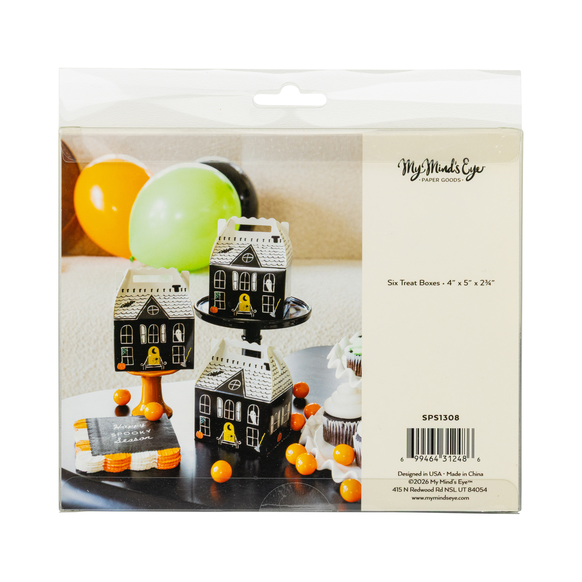Packaging of haunted house-shaped treat boxes with balloons on a white background