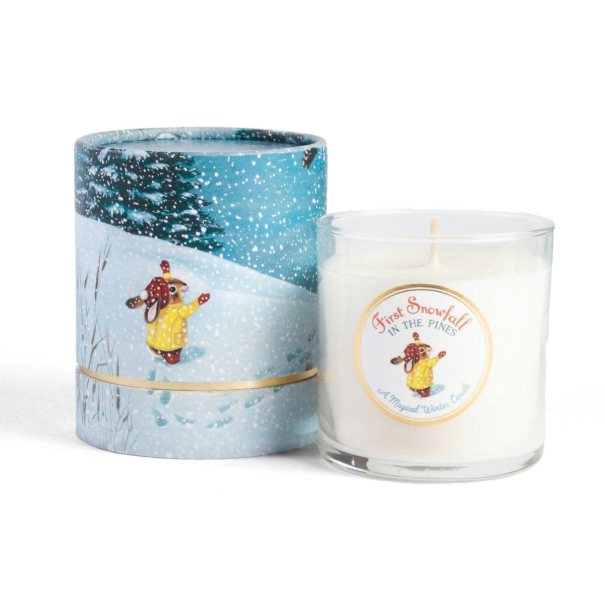 First Snowfall in the Pines soy candle in a glass jar beside its illustrated cylindrical gift box