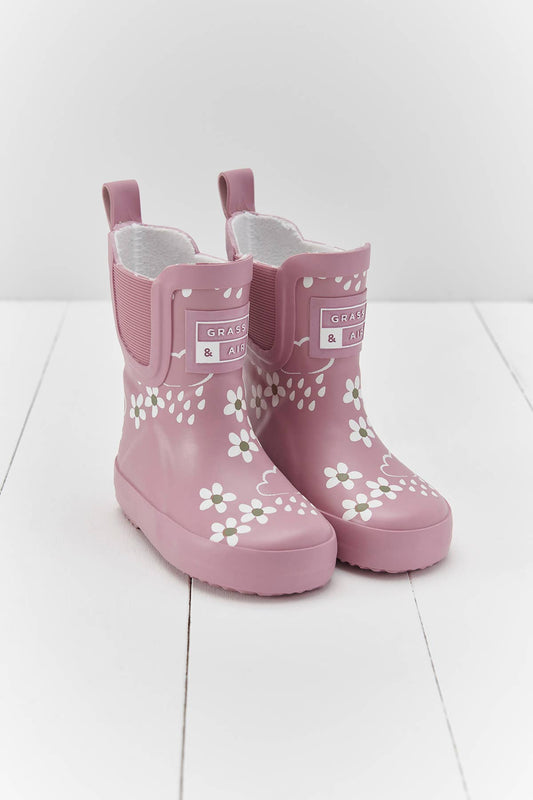 pink rain boots with floral and raindrop pattern on white background
