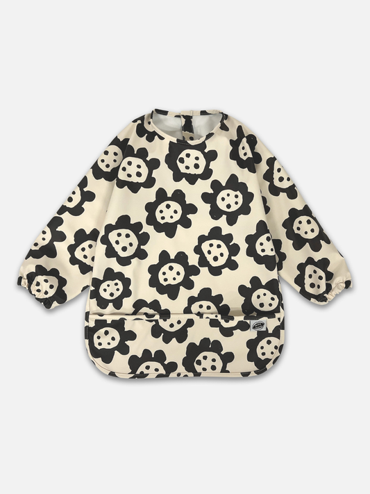 Long sleeve baby bib with black flower pattern on a white background
