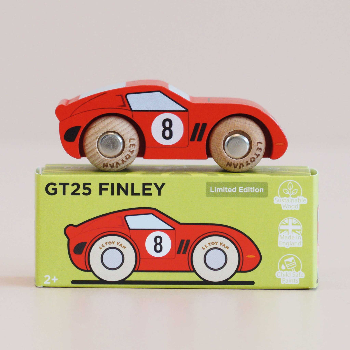 Wooden toy car with 'GT25 Finley' packaging on a light beige background