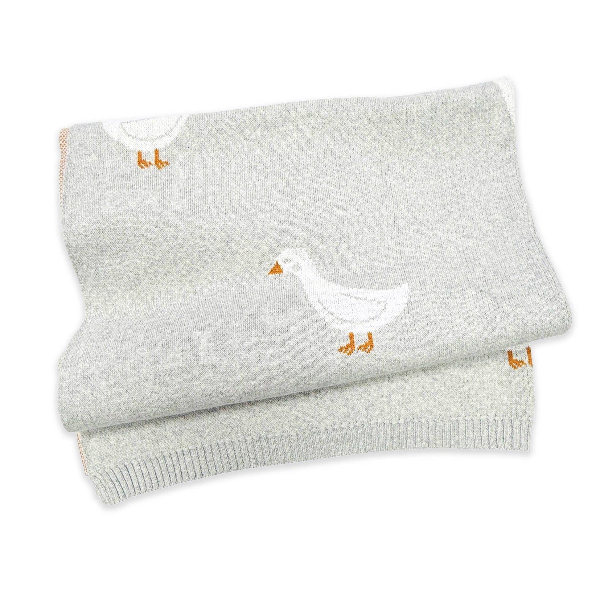 Folded gray blanket with a duck design on a white background