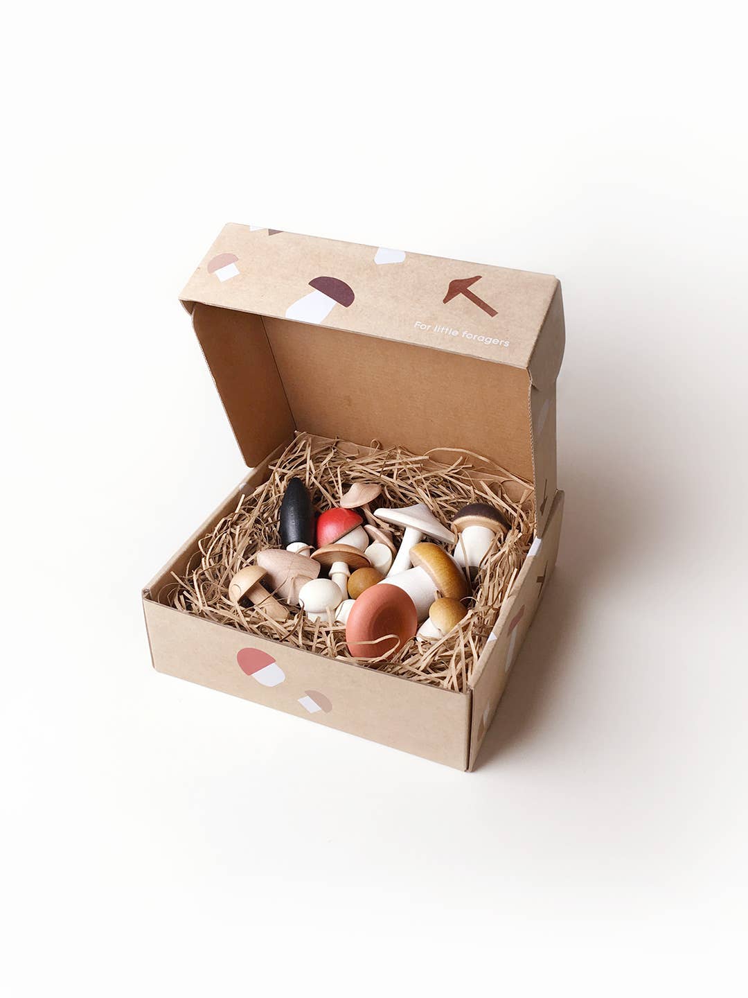 Box full of wooden mushrooms, with lid open, shown on a white background