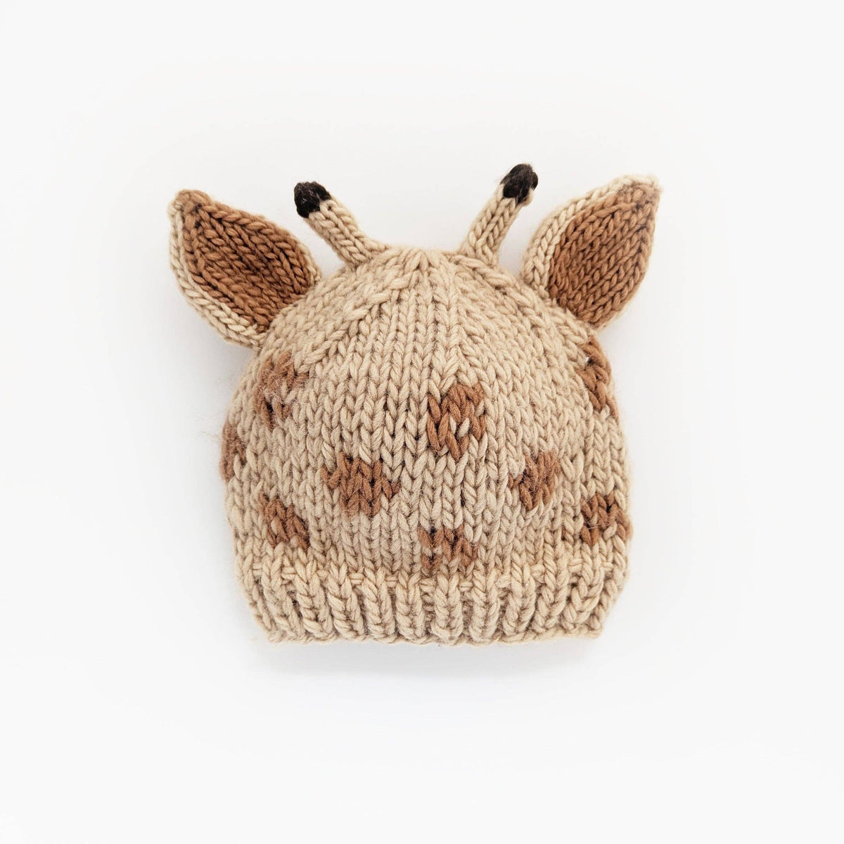 Knitted hat made to look like a giraffe, shown on a white background