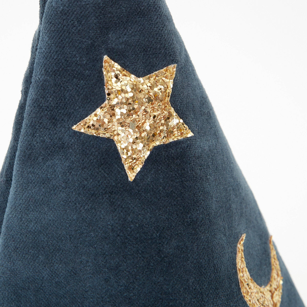 Close-up of a dark navy blue velvet fabric item featuring a prominent gold glitter star applique and a partial gold glitter crescent moon on a white background.