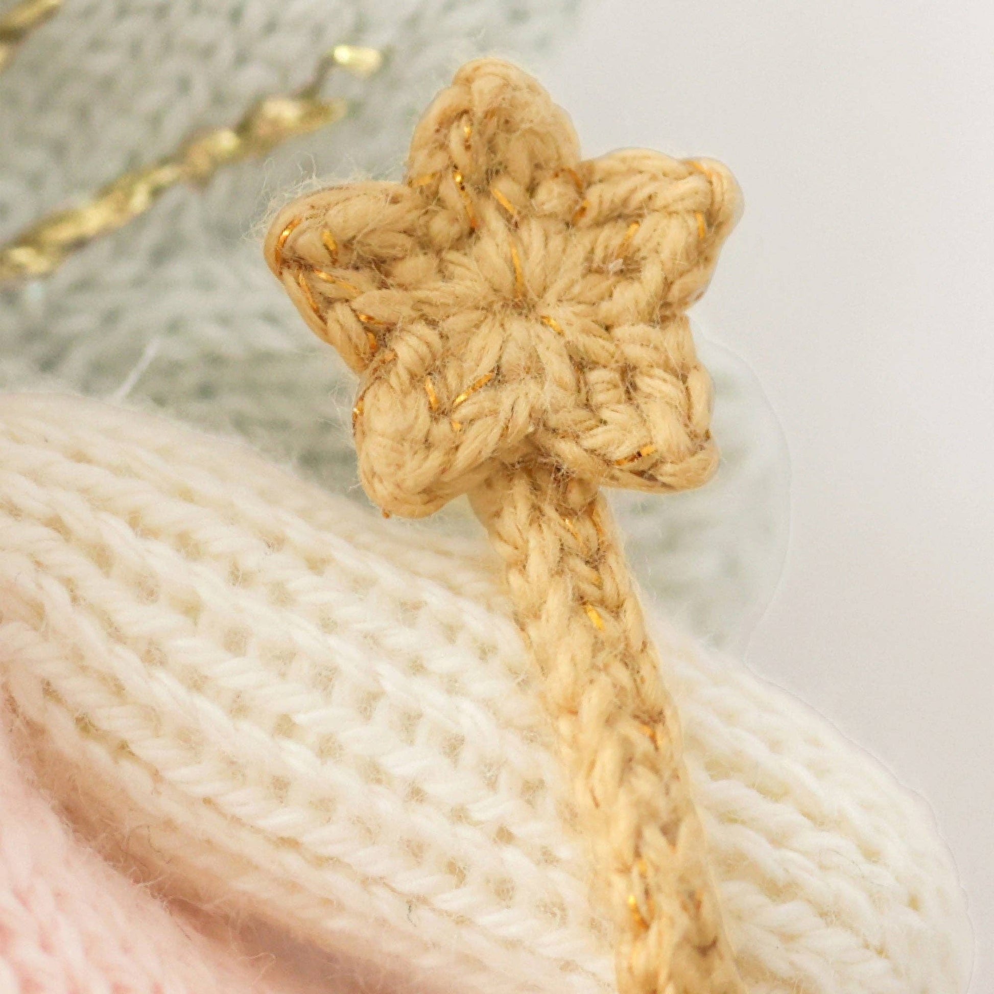 close up of knitted gold fairy wand