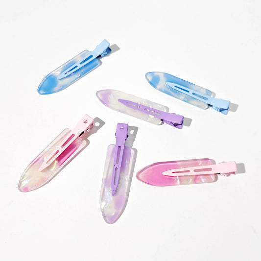 Set of colorful hair clips on a white background