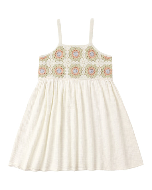 White dress with floral crochet details on a white background
