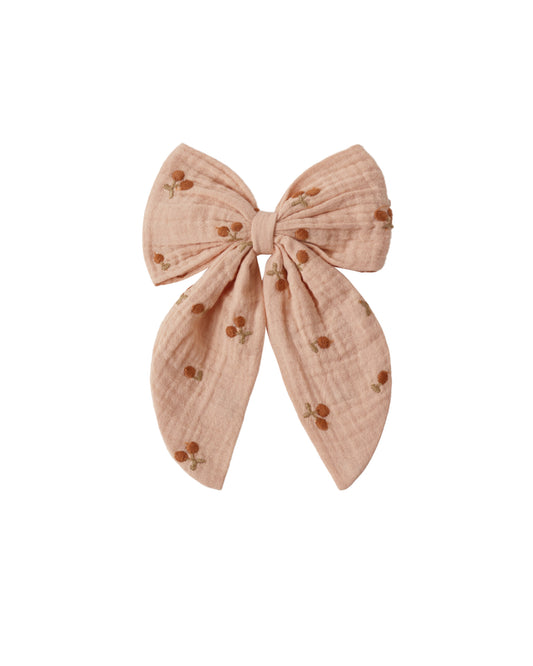 Pink hair bow with cherries on a white background
