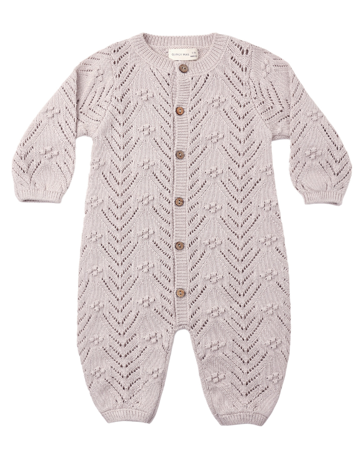 Crocheted baby romper in lilac gray color with buttons down the front, shown on a white background