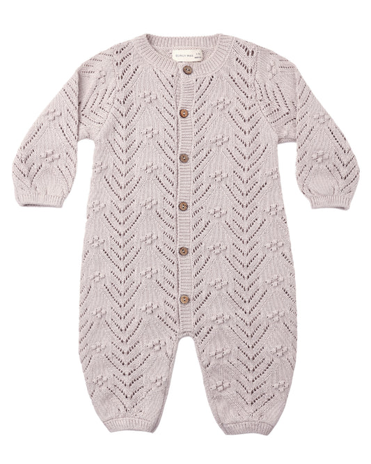 Crocheted baby romper in lilac gray color with buttons down the front, shown on a white background