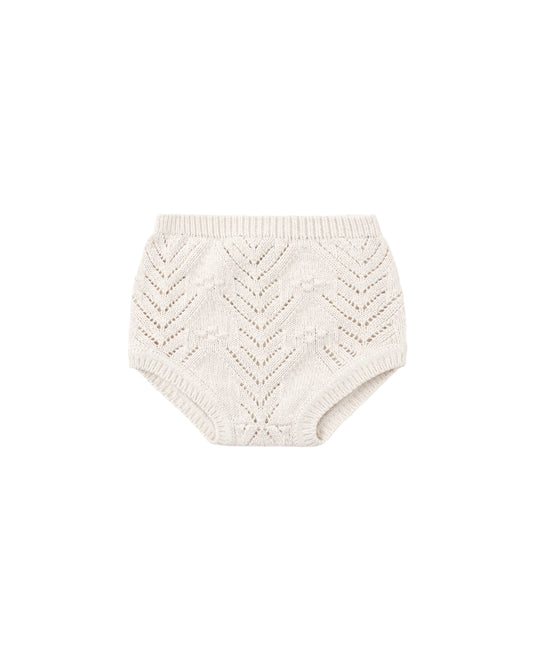 Knitted baby bloomers in oatmeal color, shown on a white background