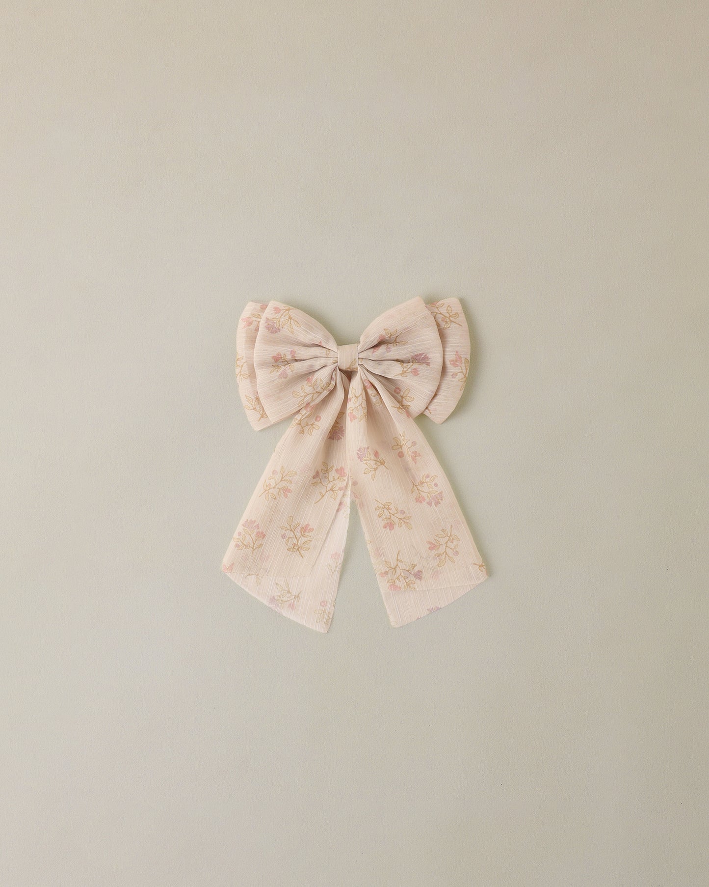 Floral bow on a light green background