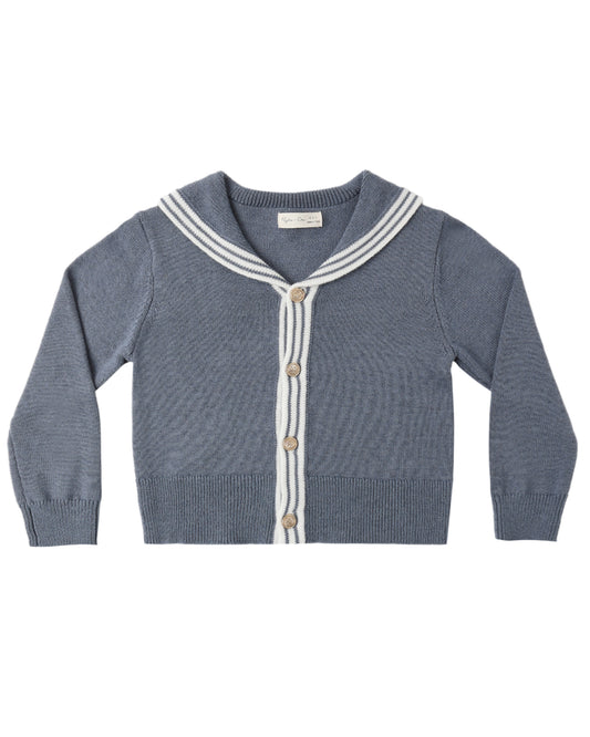 Blue knitted cardigan with white trim on a white background