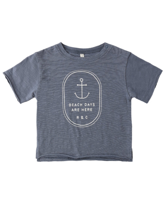 Blue t-shirt with anchor design and text on a white background