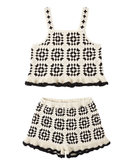 Black and white patterned crochet top and shorts set on a white background