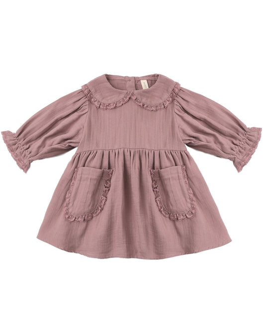 Pink dress with ruffled details on a white background
